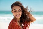 beautiful-latin-woman-enjoying-wind-at-beach-YUD7YYX-768x512.jpg